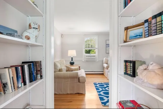 a living room with furniture and a book shelf