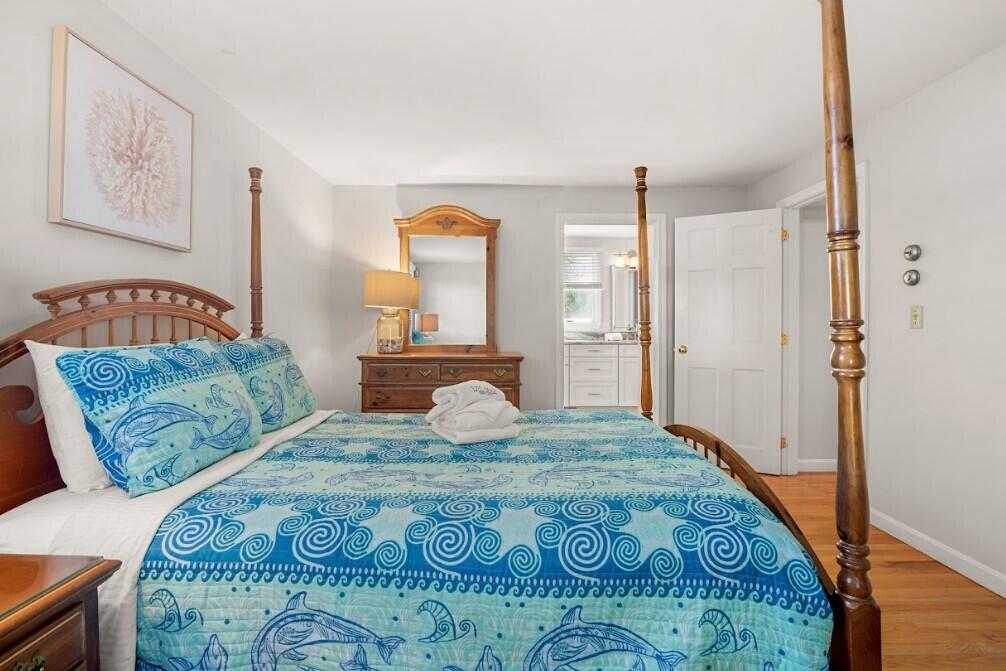 11 Fox Ridge Drive Orleans, MA 02653 - Photo 25 of 57 a bedroom with a large bed and a chandelier