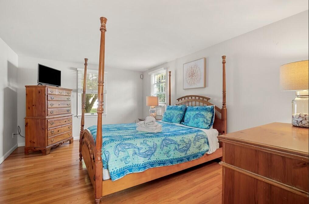 11 Fox Ridge Drive Orleans, MA 02653 - Photo 26 of 57 a bedroom with a bed and wooden floor