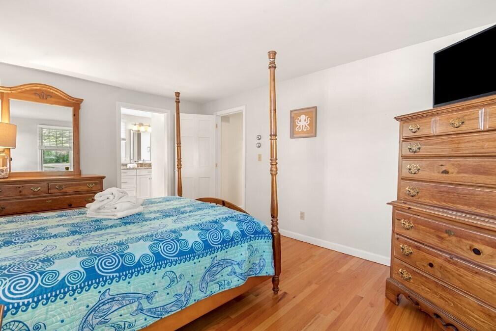 11 Fox Ridge Drive Orleans, MA 02653 - Photo 27 of 57 a bedroom with a bed and wooden floor