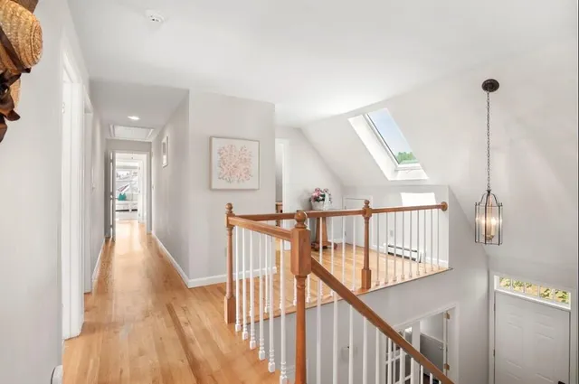 a view of kitchen with wooden floor and electronic appliances