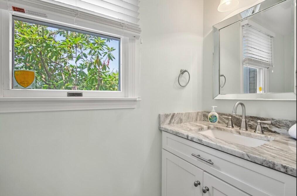 11 Fox Ridge Drive Orleans, MA 02653 - Photo 41 of 57 a bathroom with a granite countertop sink a window and a mirror