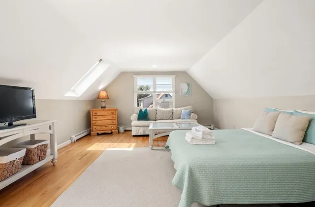 a spacious bedroom with a bed and a flat screen tv