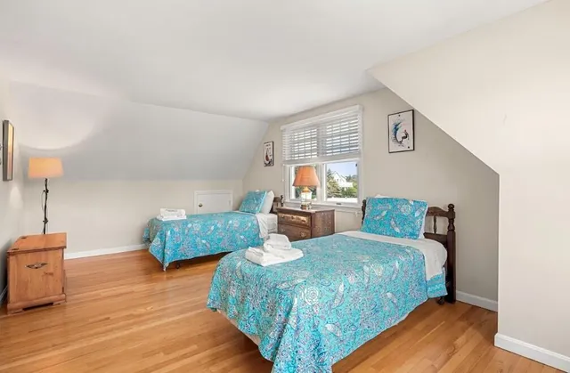 a bedroom with furniture and wooden floor