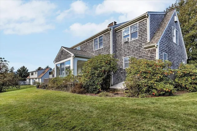 a front view of a house with garden