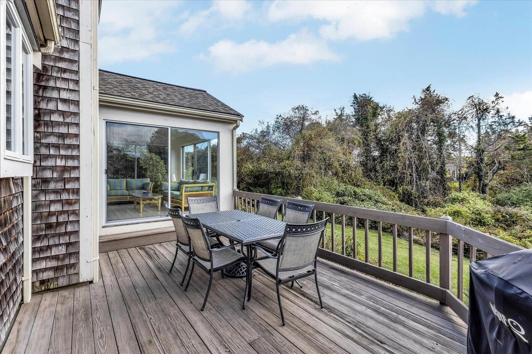 11 Fox Ridge Drive Orleans, MA 02653 - Photo 9 of 57 a balcony with wooden floor table and chairs