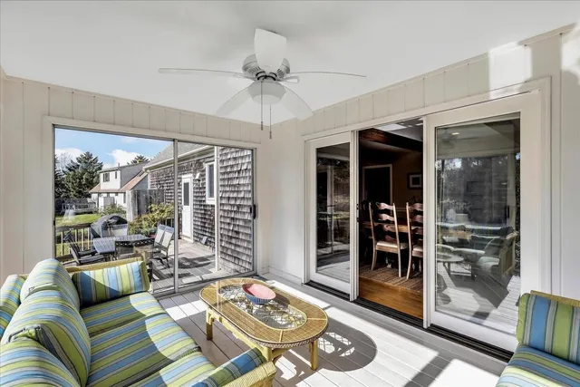 a living room with furniture and a floor to ceiling window