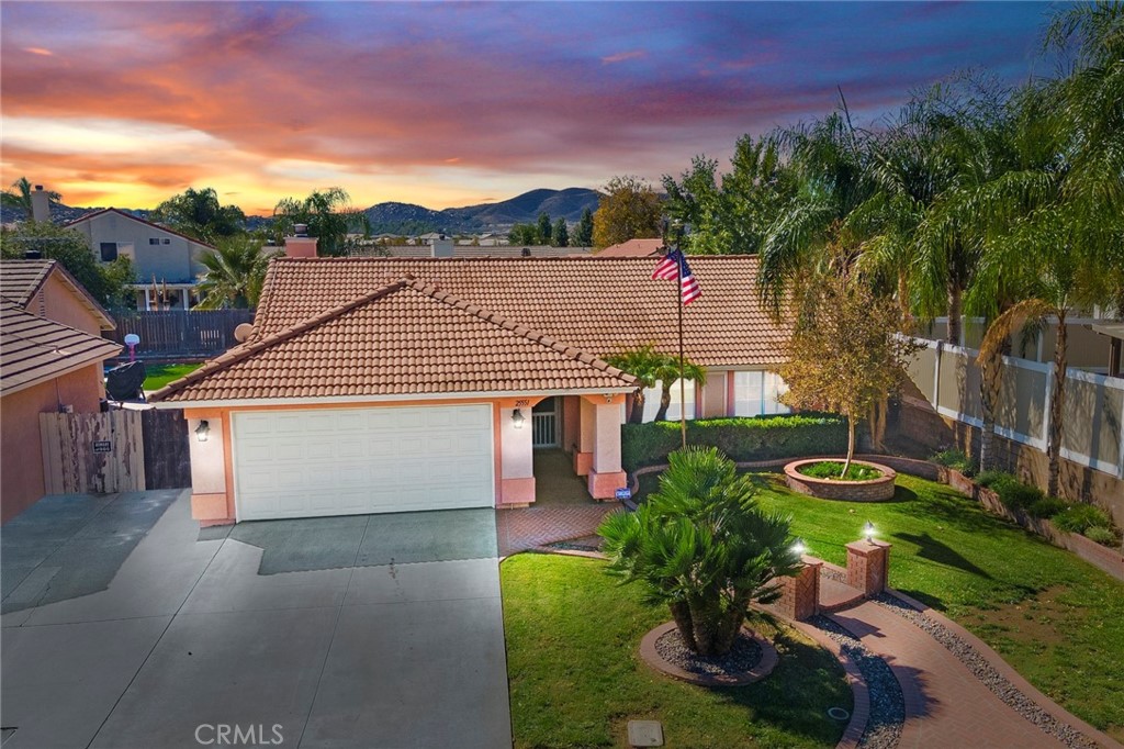 25551 Pelion Road Menifee, CA 92584 - Photo 1 of 1 a view of a white house with a yard and potted plants