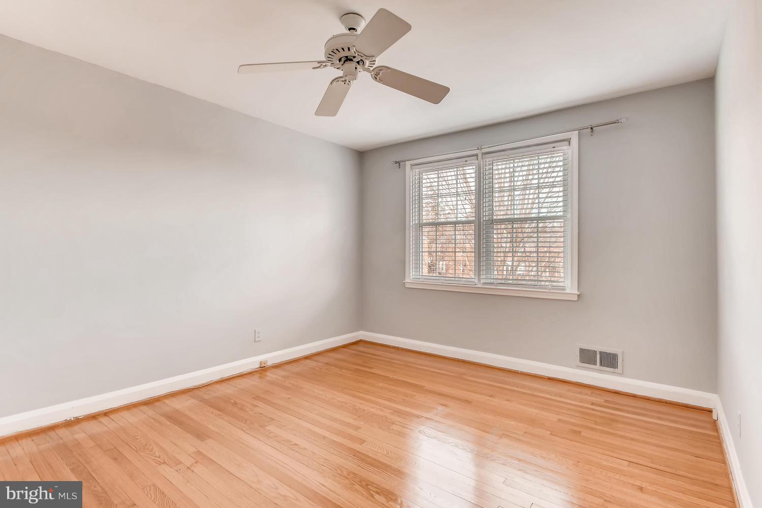 7013 Heathfield Road Baltimore, MD 21212 - Photo 13 of 33 a view of empty room with wooden floor and fan