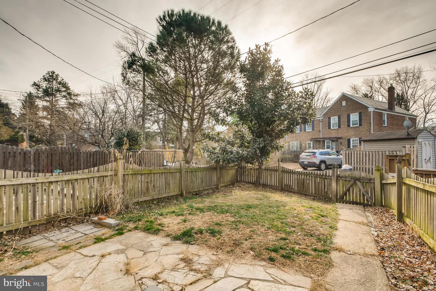 7013 Heathfield Road Baltimore, MD 21212 - Photo 27 of 33 a view of a backyard with a large tree and wooden fence