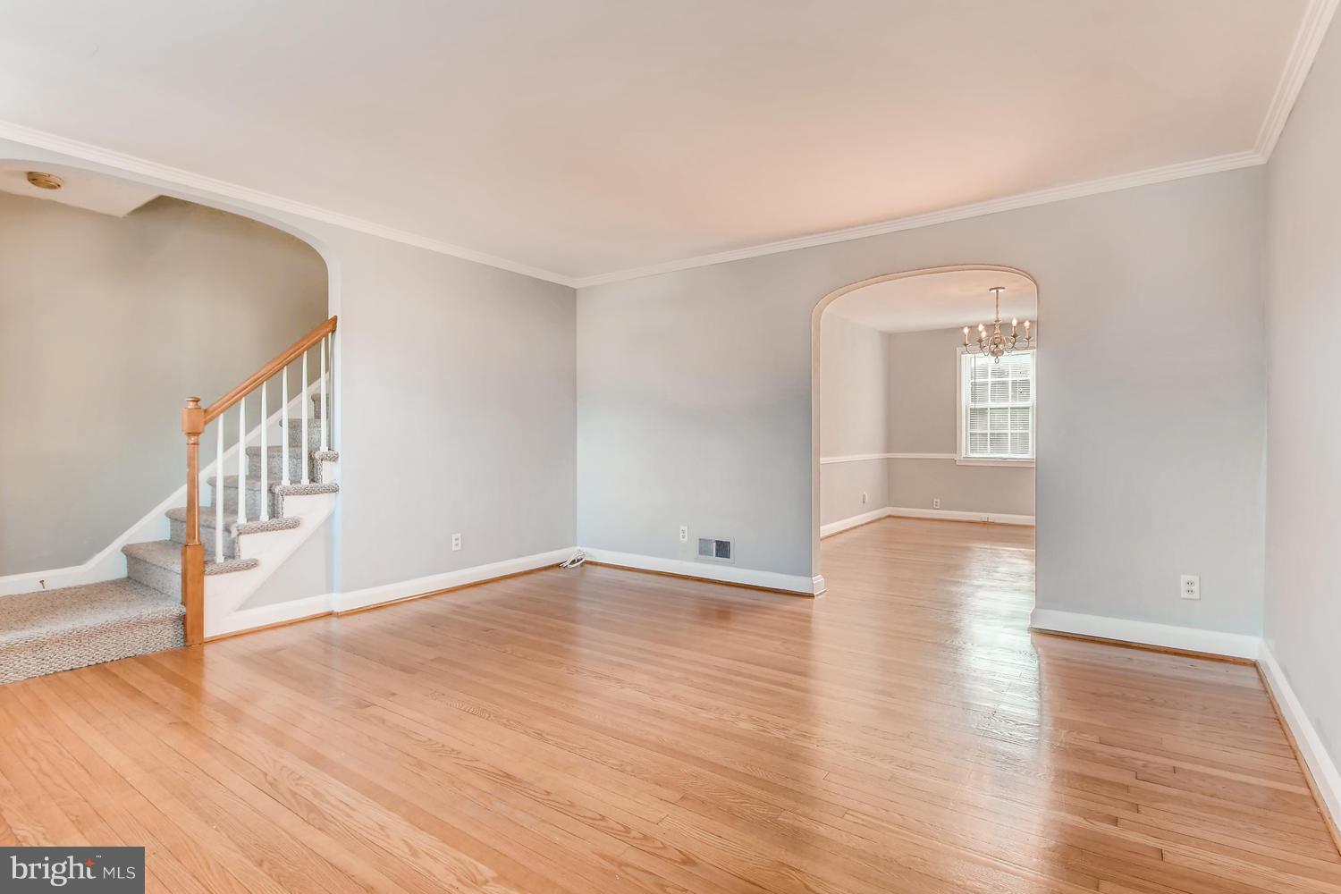 7013 Heathfield Road Baltimore, MD 21212 - Photo 4 of 33 a view of an empty room with wooden floor and a window