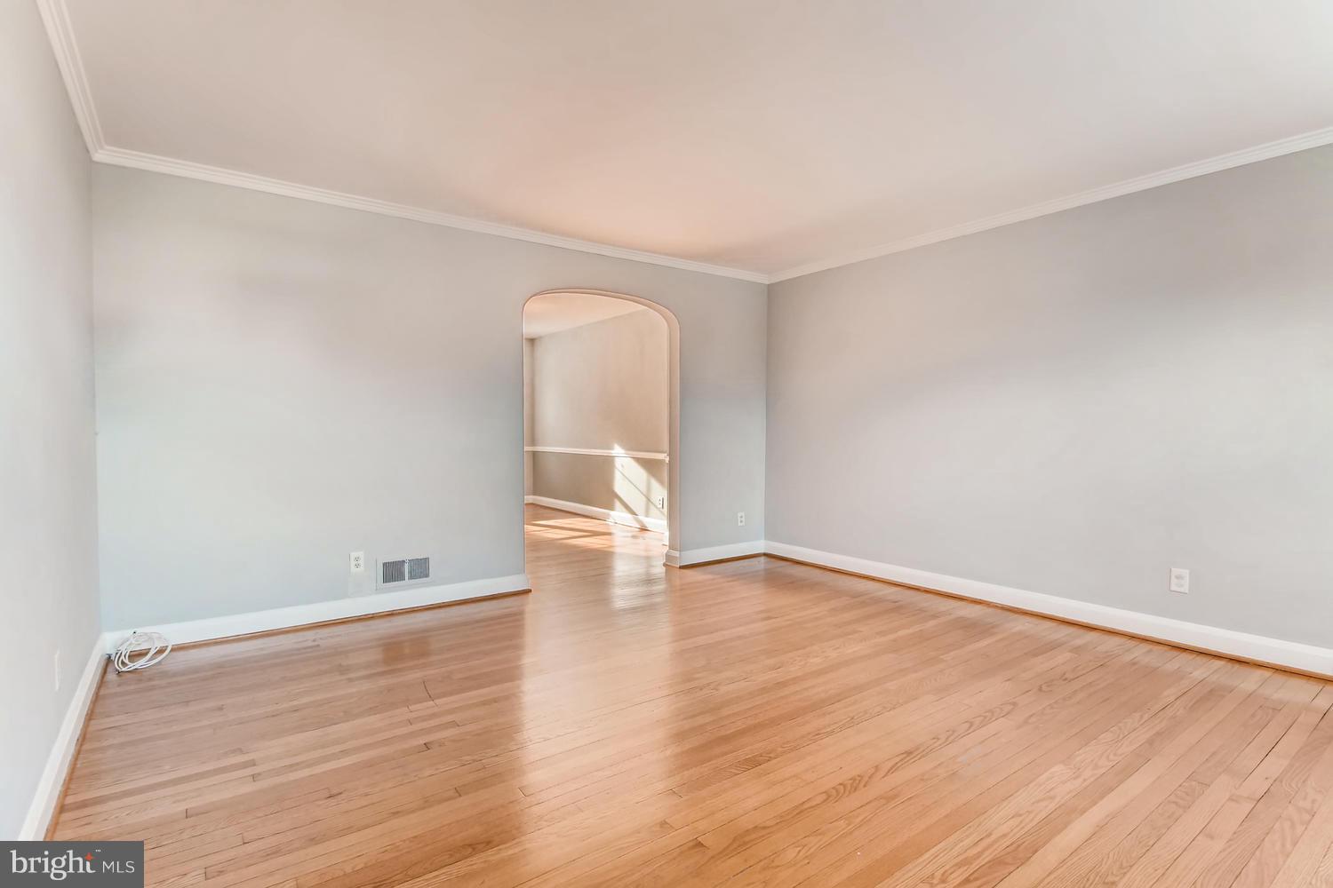 7013 Heathfield Road Baltimore, MD 21212 - Photo 5 of 33 an empty room with wooden floor and windows