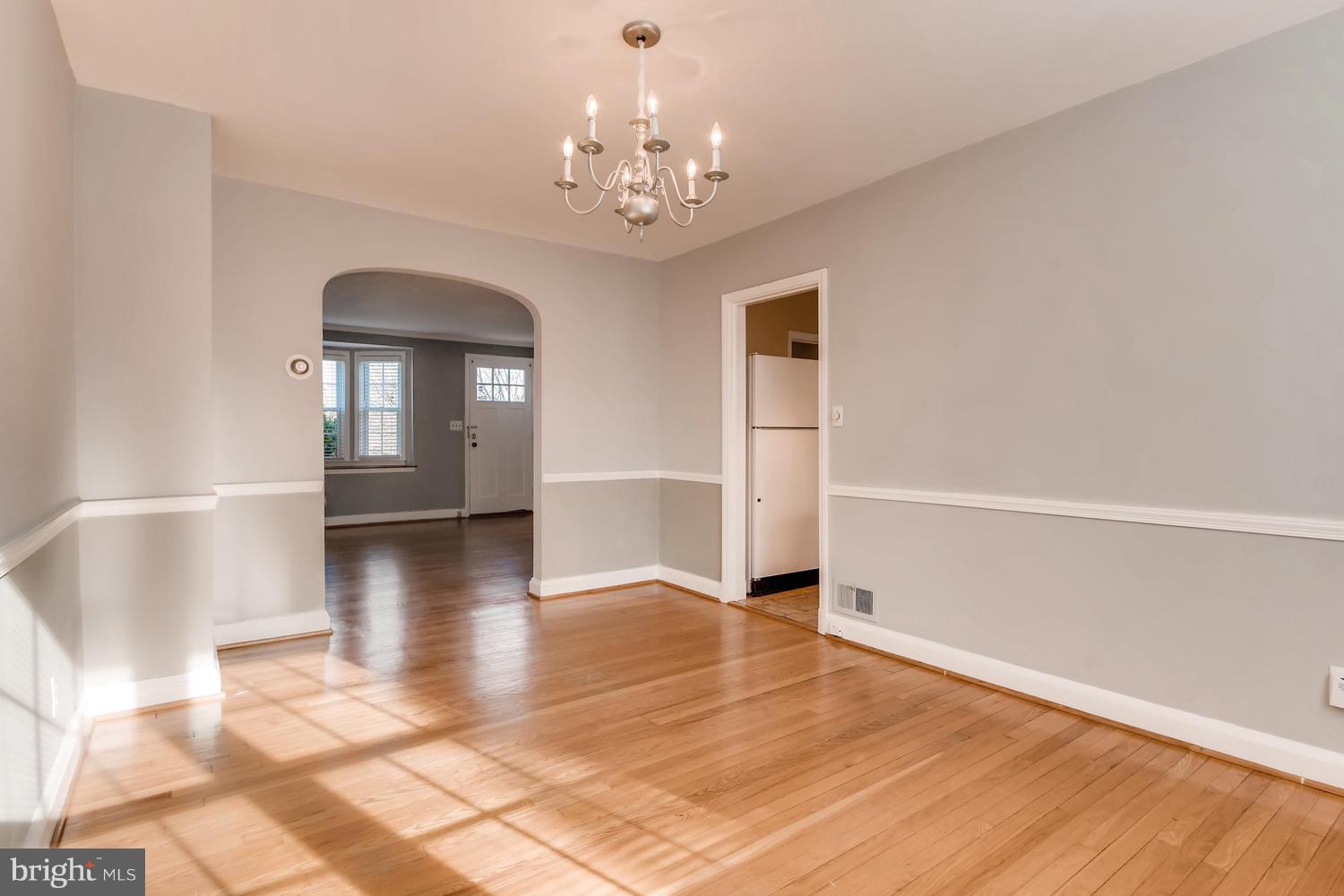 7013 Heathfield Road Baltimore, MD 21212 - Photo 8 of 33 a view of a livingroom with wooden floor and a chandelier