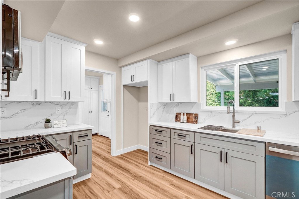 1355 Limerick Drive Placentia, CA 92870 - Photo 11 of 33 a kitchen with granite countertop a sink stove and cabinets