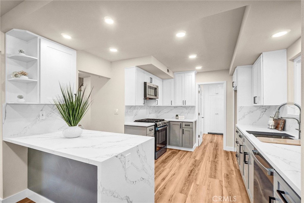 1355 Limerick Drive Placentia, CA 92870 - Photo 10 of 33 a kitchen with stainless steel appliances kitchen island granite countertop a sink a stove and a refrigerator