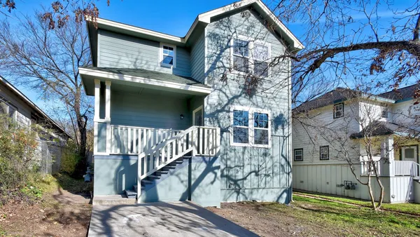 a view of a house with a tree