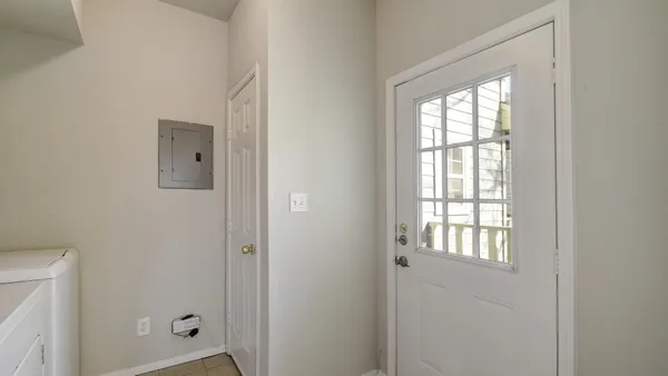 a view of an entryway with wooden floor