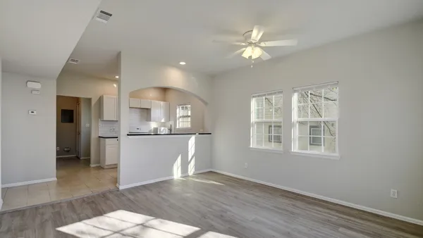 a view of a livingroom with a furniture wooden floor and a window