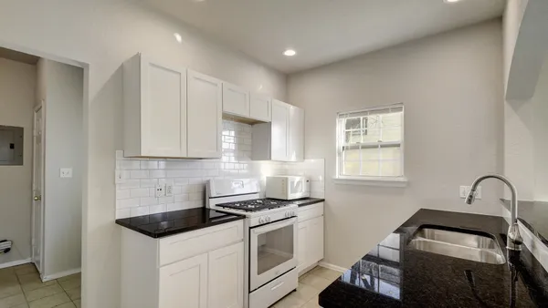 a kitchen that has a sink and a stove in it