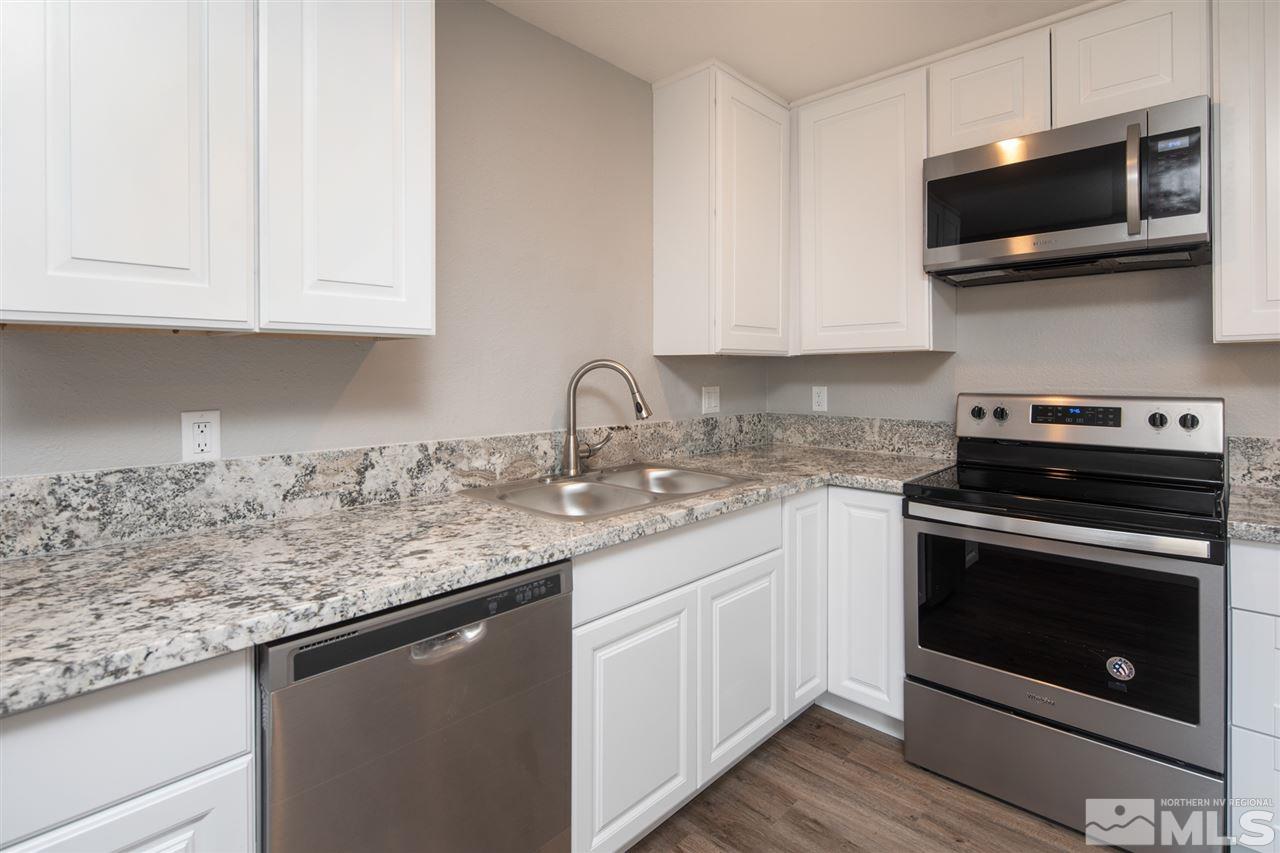 625 Akard Circle Reno, NV 89503 - Photo 10 of 27 a kitchen with stainless steel appliances granite countertop a sink a stove a microwave and cabinets