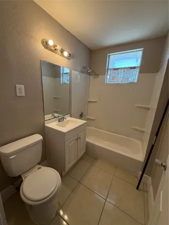 a bathroom with a sink a toilet a mirror and a bathtub