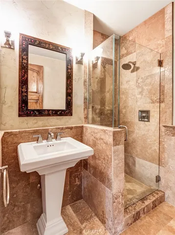 a bathroom with a sink mirror and a shower