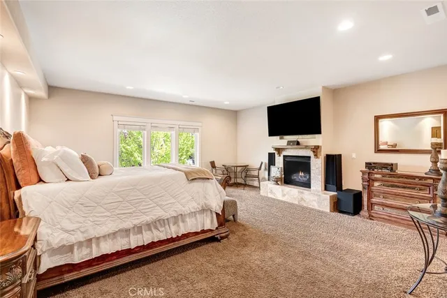 a spacious bedroom with a bed and a flat screen tv