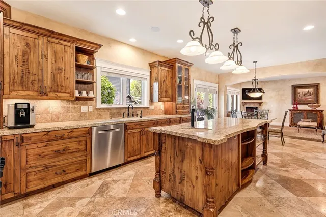 a kitchen with stainless steel appliances granite countertop a stove and a sink