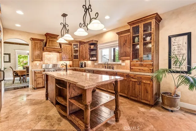a kitchen with a stove a sink and a refrigerator