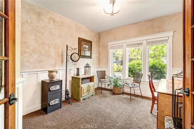 a view of a workspace with furniture and a window