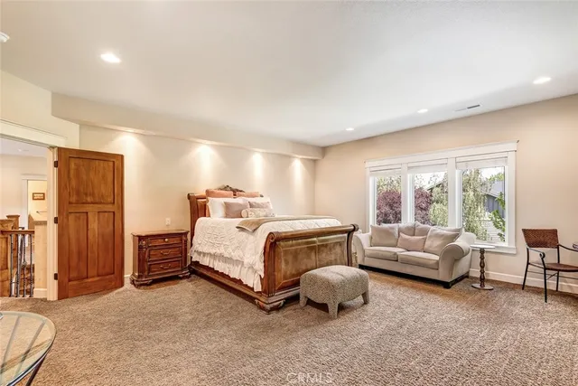 a spacious bedroom with a bed and a couch