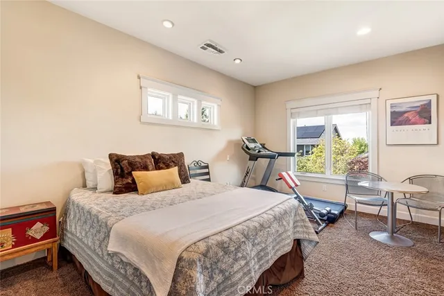 a bedroom with a bed a table and chair