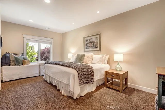 a spacious bedroom with a bed and a couch