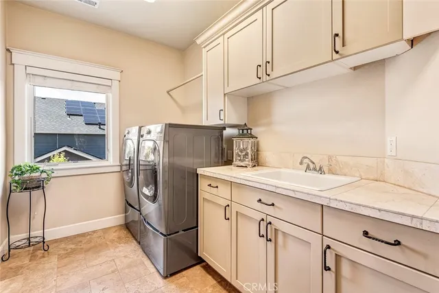 a kitchen with a refrigerator sink and cabinets