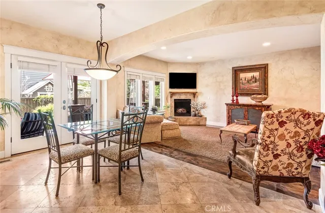 a living room with furniture or chandelier and a wooden floor