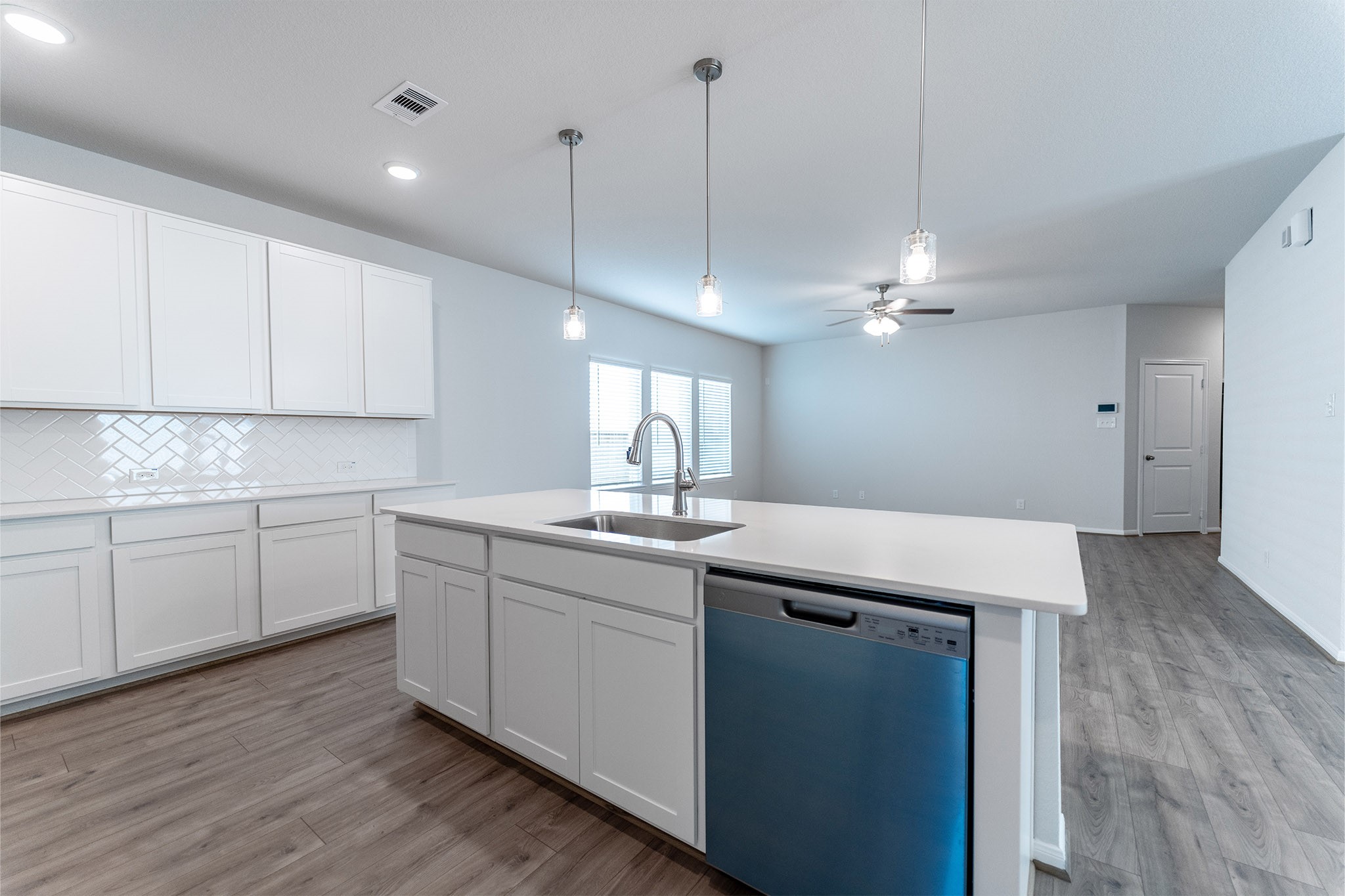 418 Hazy Meadows Drive Beasley, TX 77417 - Photo 11 of 17 a kitchen with a sink cabinets and wooden floor