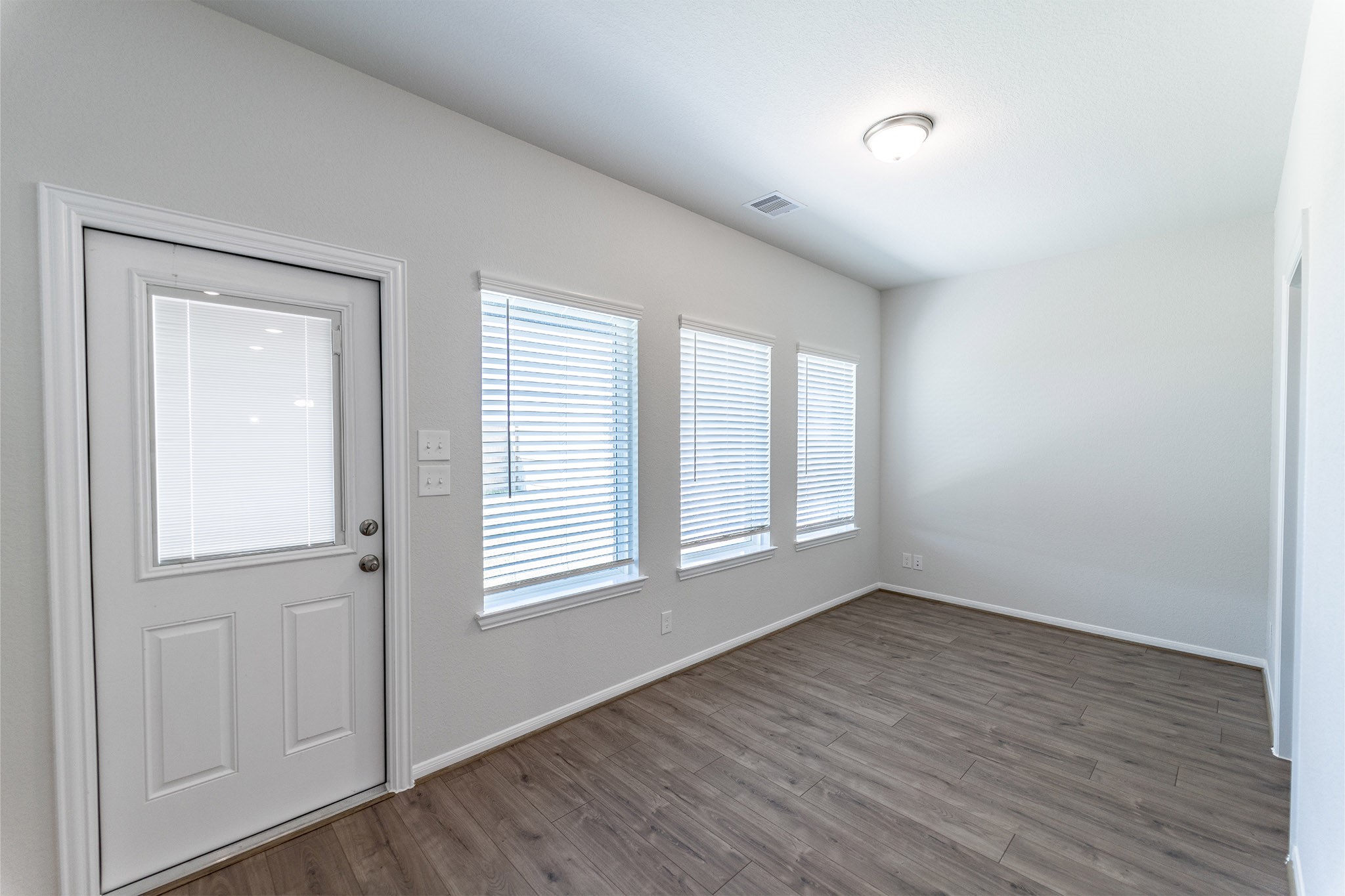 418 Hazy Meadows Drive Beasley, TX 77417 - Photo 3 of 17 an empty room with wooden floor and windows