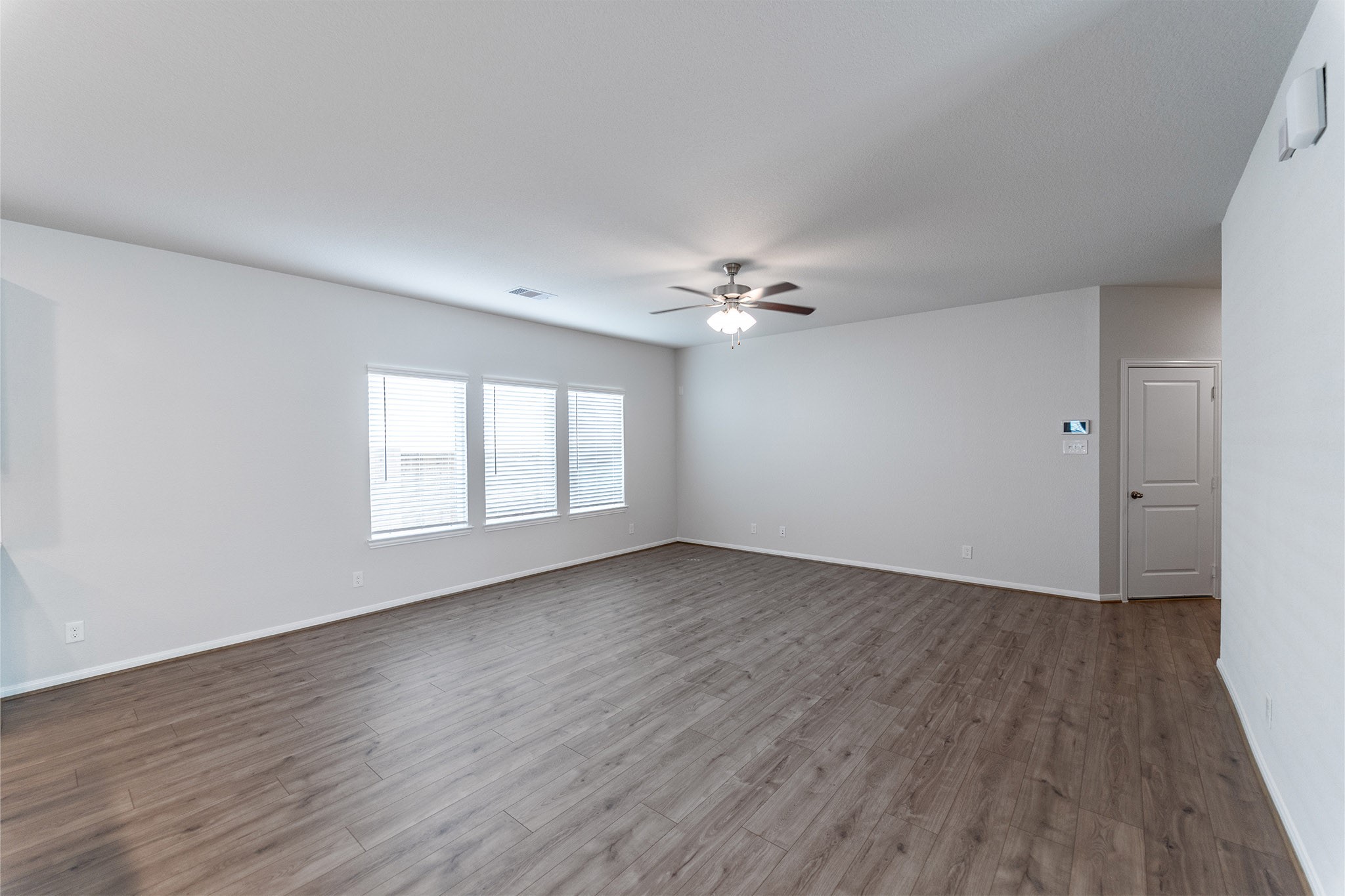 418 Hazy Meadows Drive Beasley, TX 77417 - Photo 5 of 17 a view of an empty room with wooden floor and a window