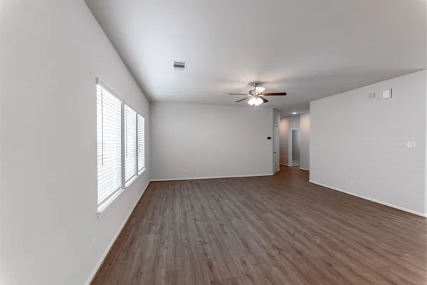 a view of a livingroom with a ceiling fan and window