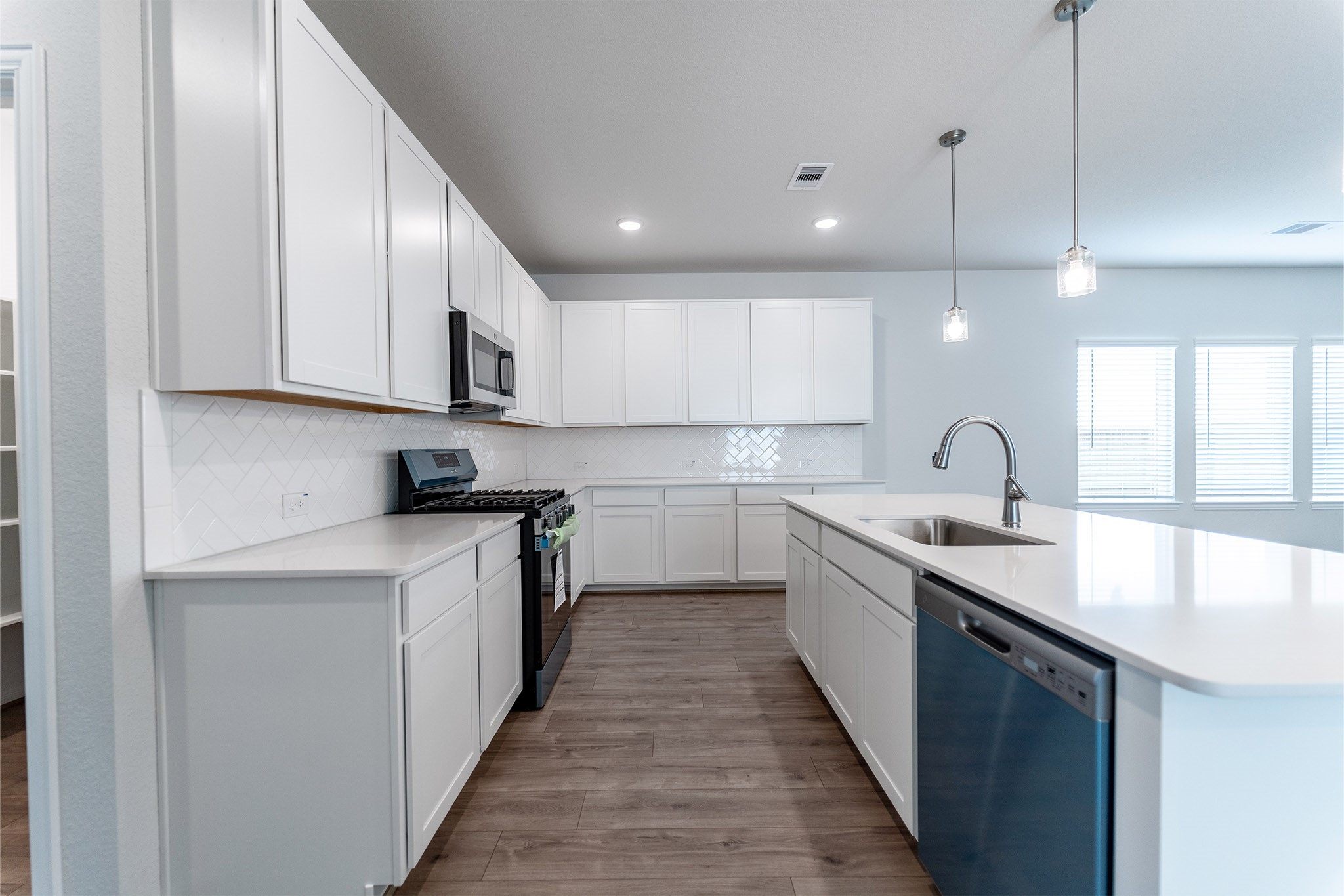 418 Hazy Meadows Drive Beasley, TX 77417 - Photo 10 of 17 a kitchen with white cabinets appliances and a sink
