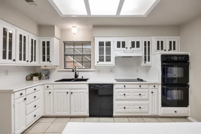 a kitchen with stainless steel appliances kitchen island granite countertop a refrigerator and a stove