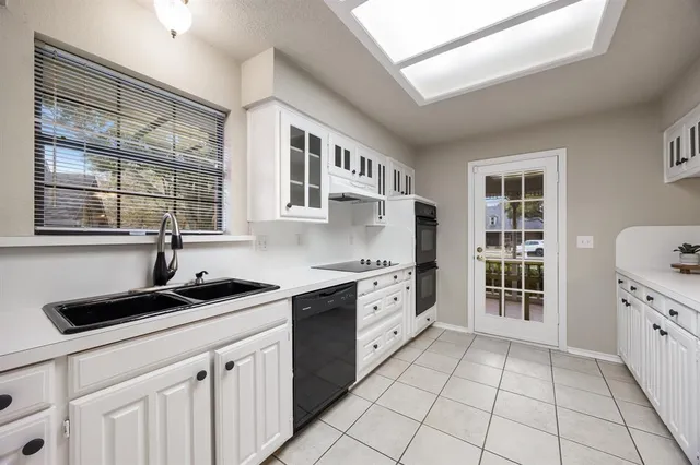 a kitchen with stainless steel appliances a sink stove and cabinets