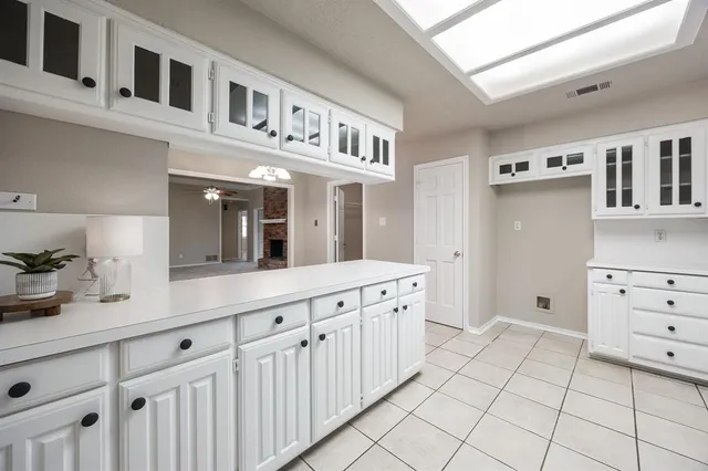 a kitchen with cabinets and window