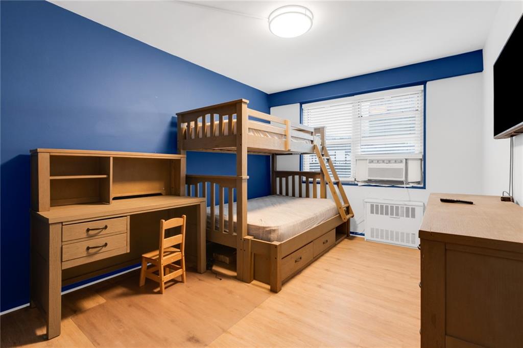 2940 West 5th Street, Unit 2B Brooklyn, NY 11224 - Photo 12 of 25 a bedroom with a bed and a dresser next to a window