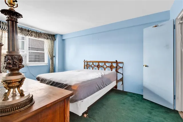 a bedroom with a bed and windows