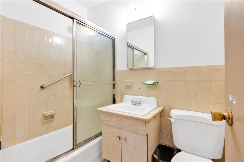 2940 West 5th Street, Unit 2B Brooklyn, NY 11224 - Photo 18 of 25 a bathroom with a sink toilet and shower