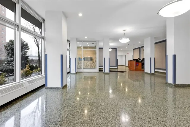 a kitchen with a stove a sink and a dining table with rug