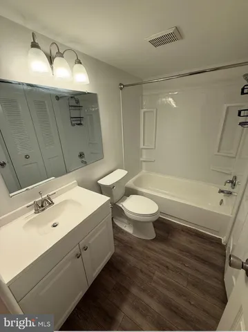 a bathroom with a double vanity sink toilet and shower