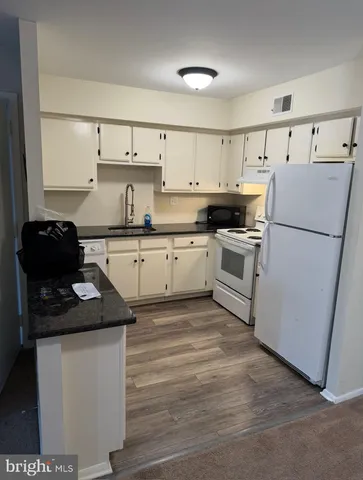 a kitchen with a sink a stove and refrigerator