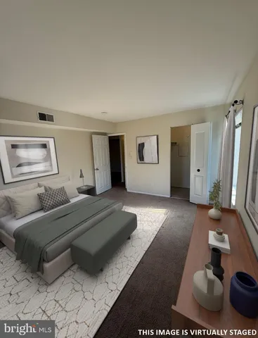 a spacious bedroom with a bed and a couch